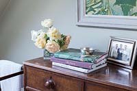 Vase of Roses on chest of drawers