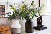 Roses and Eucalyptus foliage in black vase