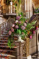Floral display with Peonies, Alliums and Larkspur flowers at foot of the great staircase