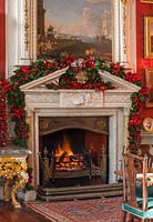 The fireplace in the crimson dining room decorated for christmas, Castle Howard