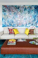 Colourful abstract painting above sofa