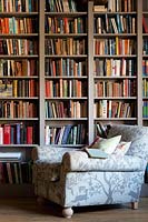 Armchair by bookshelves