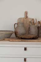 Kitchen utensils in rustic pots
