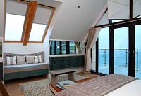 Coastal style bedroom with balcony