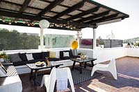 Covered seating area on roof terrace