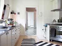Striped rugs on kitchen floor