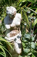 Classic statue in garden border