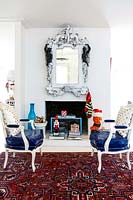 Blue armchairs beside fireplace