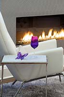 Leather armchair beside fireplace