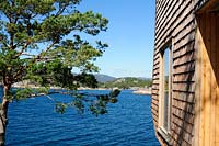Modern, larch clad cabin overlooking sea