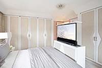 Bed with pop up TV screen