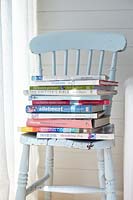 Stack of books on blue chair