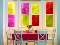 Colourful window treatment in dining area