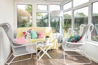White armchairs in conservatory