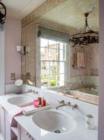 Classic bathroom sinks and antiqued glass mirror