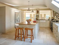 Country style kitchen with tumbled marble floor