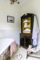 Vintage dresser in bathroom corner