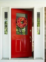Red front door with floral wreath