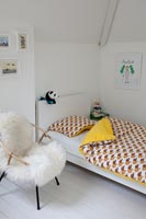 Chair with sheepskin throw in childs bedroom
