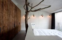 Bedroom with tree sculpture