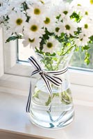 Vase of flowers on windowsill