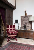 A corner of The Great Hall with a copy of a Victorian chair and 17th Century wooden coffer behind