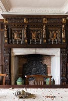 Dining room with oak panelling and ornate fireplace - Cothay Manor