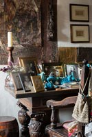 Display of family photos on antique oak table - Cothay Manor