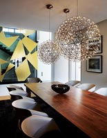 Spherical lights above dining table