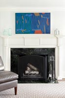 Modern painting and classic fireplace