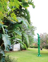 Garden with tropical planting and modern sculpture