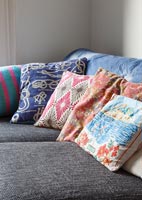 Colourful cushions on corner sofa