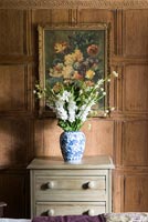 Vase of flowers on chest of drawers