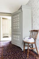Patterned cabinet in hallway