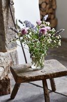 Jar of flowers on rustic stool