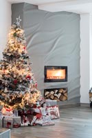 Christmas tree by fireplace