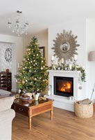 Christmas tree beside fireplace