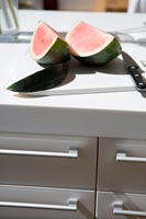 Watermelon on white chopping board