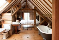 Bedroom and ensuite bathroom in converted mill