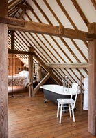 Bedroom and ensuite bathroom in converted mill
