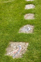 Mosaic artwork in garden path