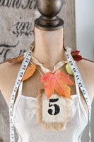 Tailors dummy decorated with autumn foliage