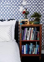 Wooden bookcase by bed