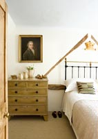 Chest of drawers beside bed