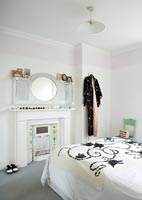 White bedroom with period fireplace
