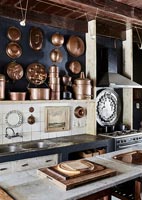 Copper cooking equipment display on kitchen wall