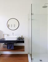 Modern bathroom sink with wooden shelf