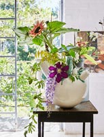 Vase of Clematis, Wisteria and Sunflowers in bathroom
