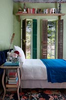 Green bedroom with shutters