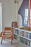 Armchair beside bookcase